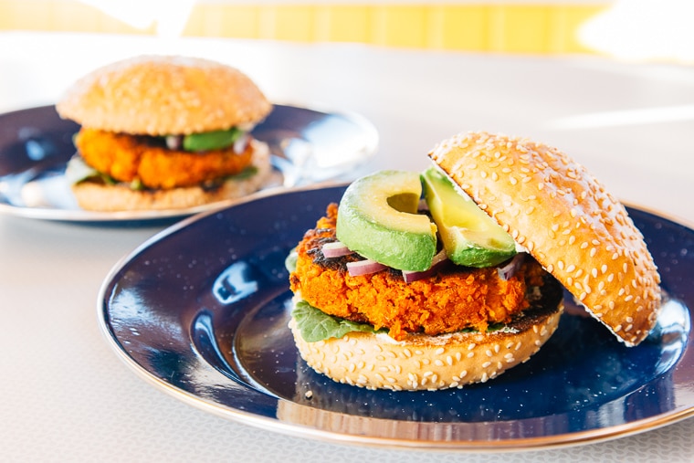 Sweet potato burger on a blue camping plate.