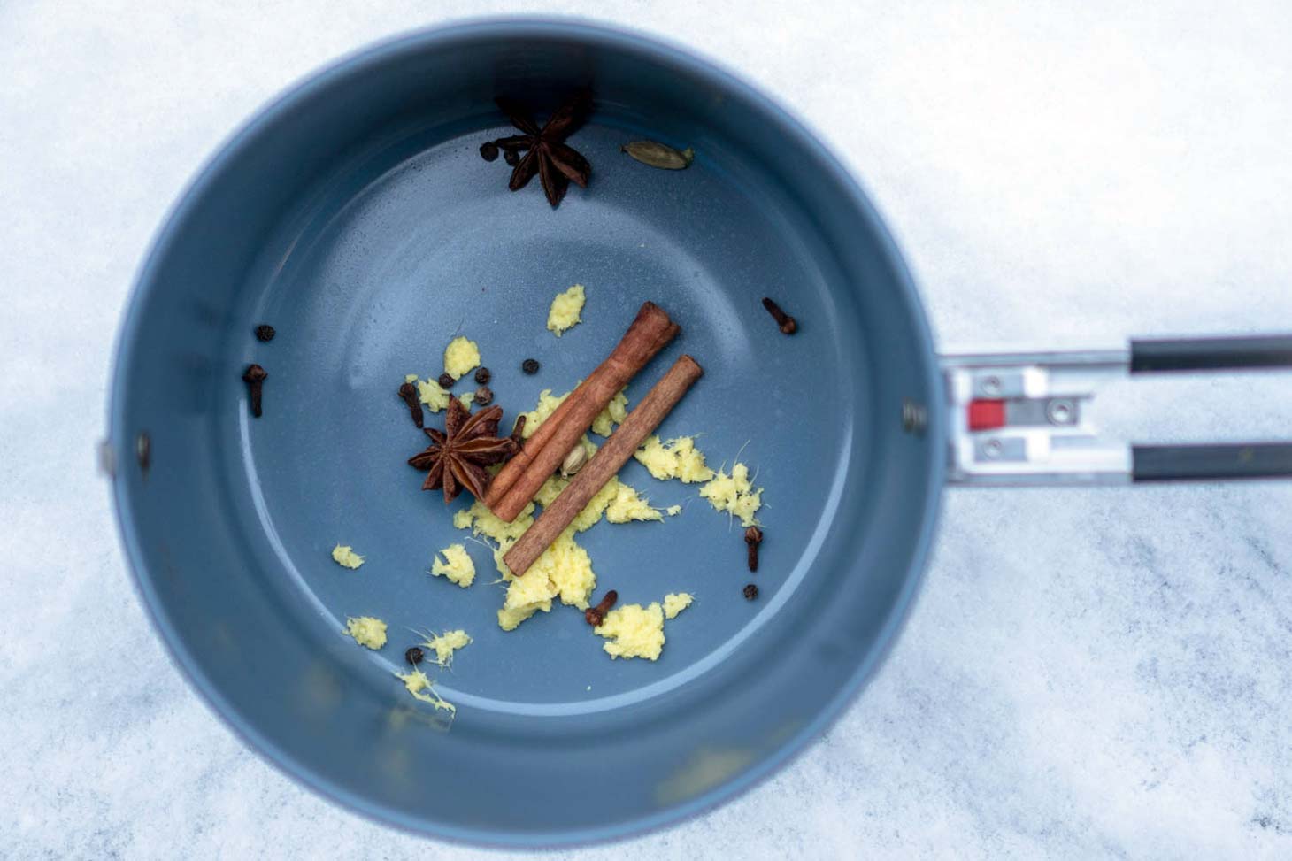 Ginger, cinnamon sticks, cloves, and star anise in a pot