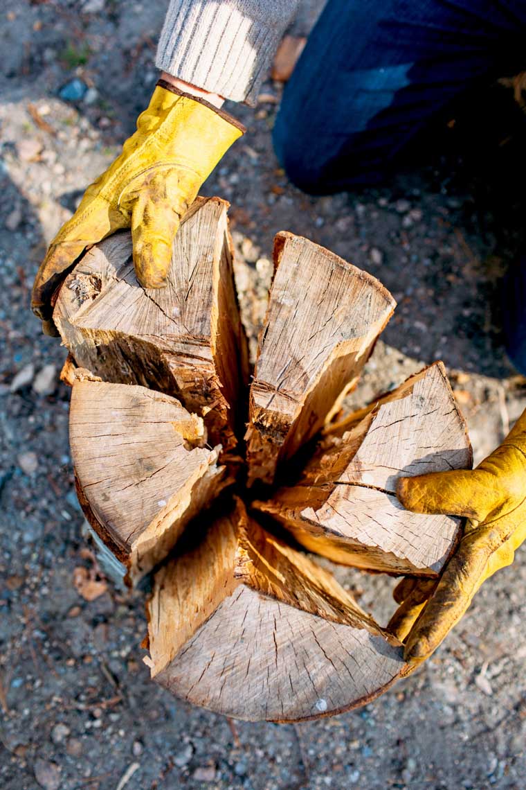 Michael making a Swedish fire log out of a bundle of firewood