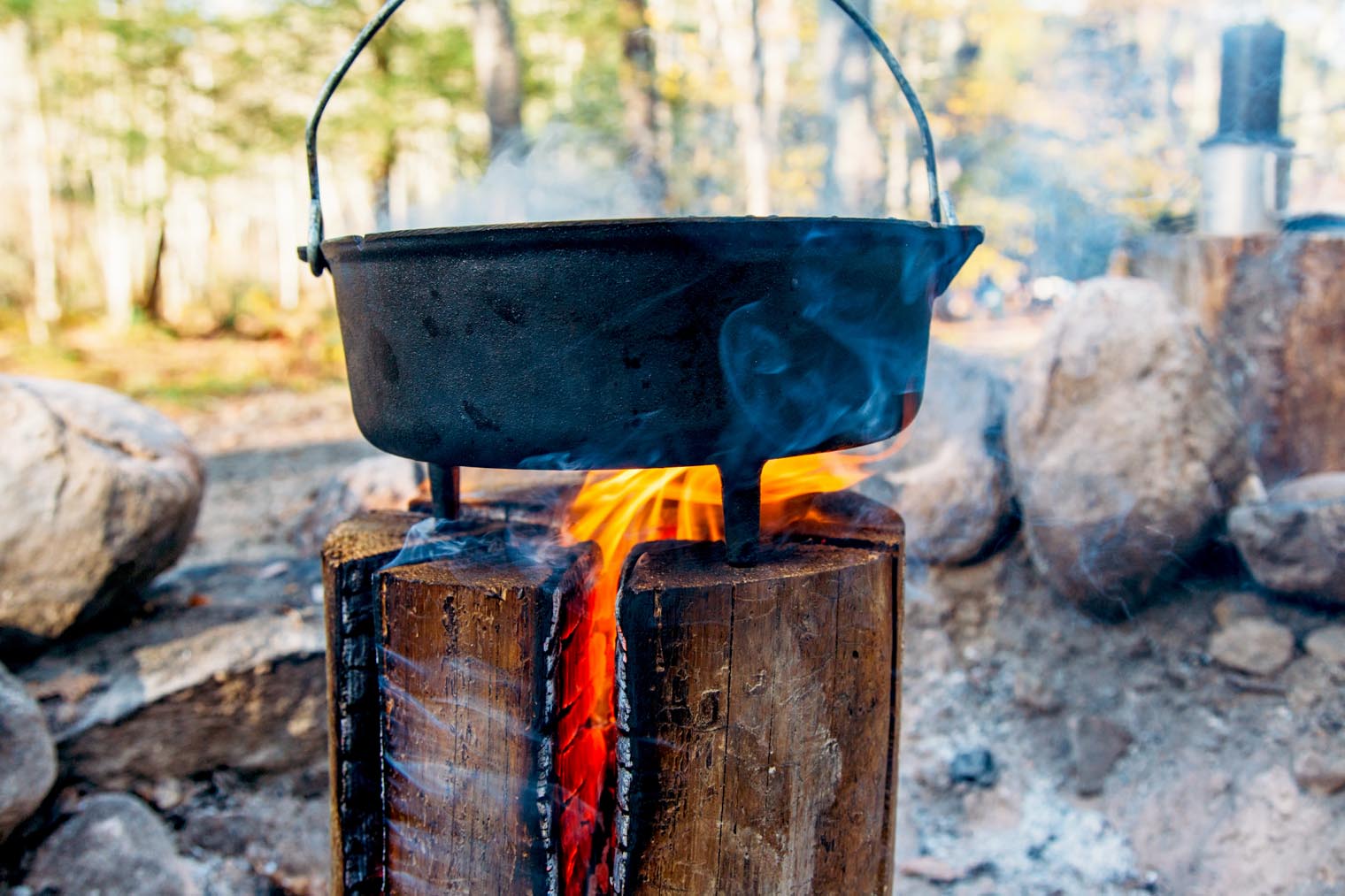 A Dutch oven sitting on the top of a Swedish firelog