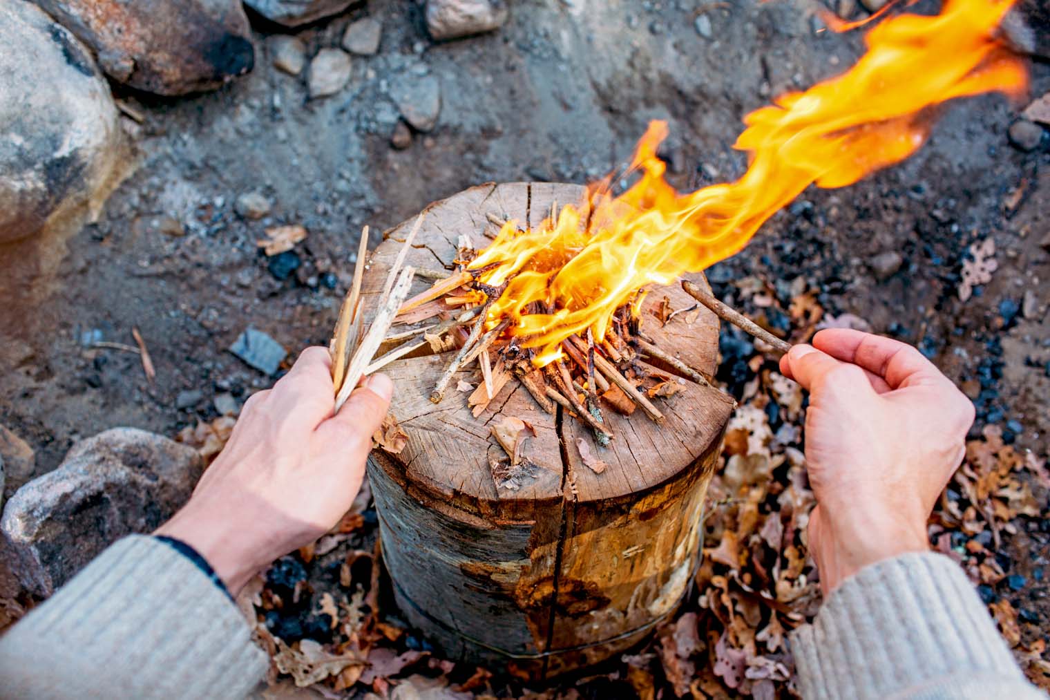 Michael adding kindling to a Swedish firelog