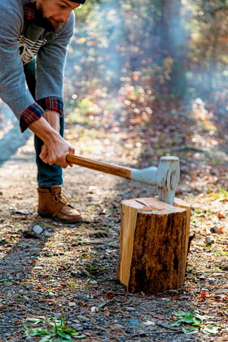 Michael splitting a stump using a wood splitter