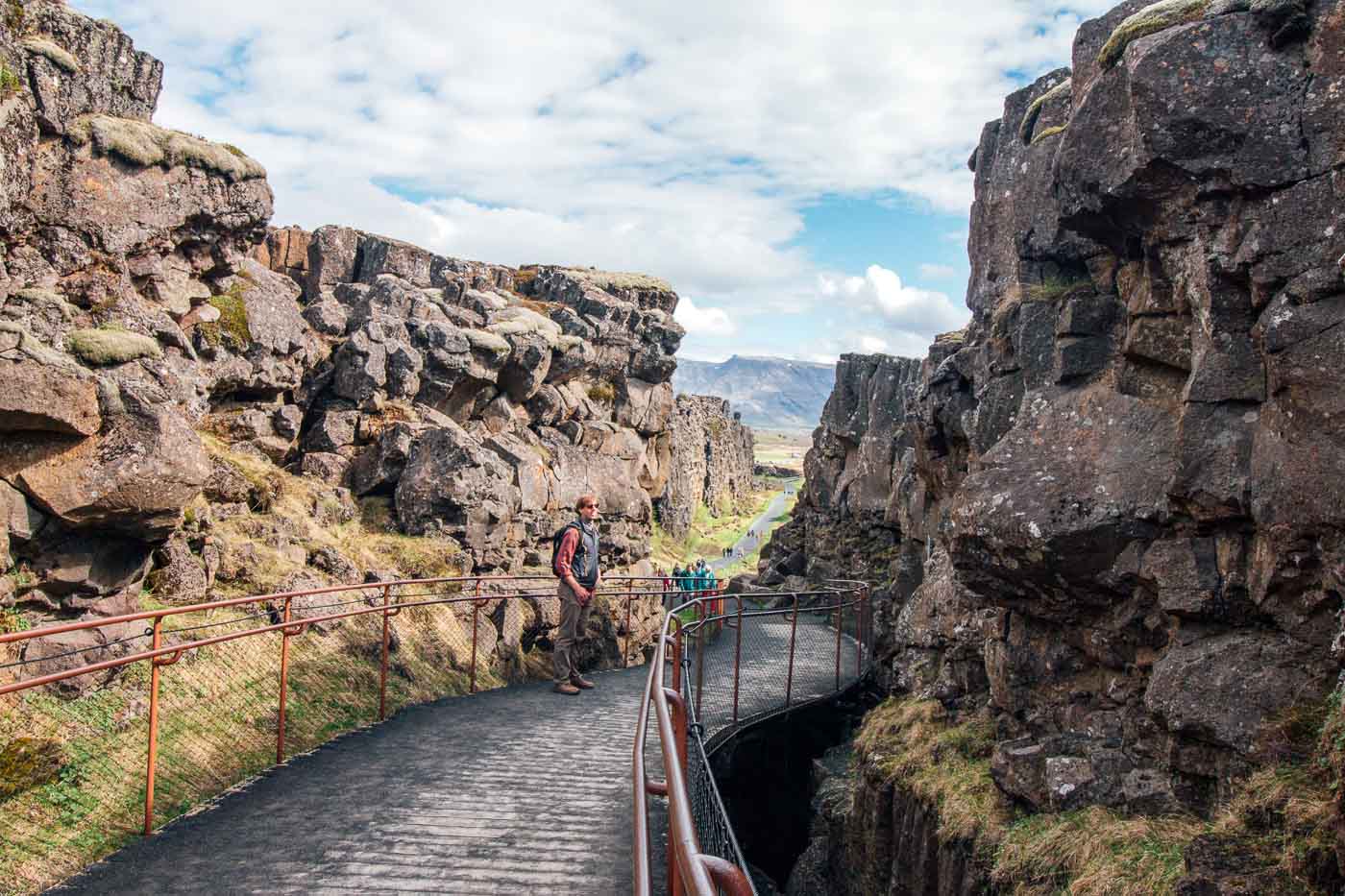 Michael walking on a pathway between rock formations at Thingvellir