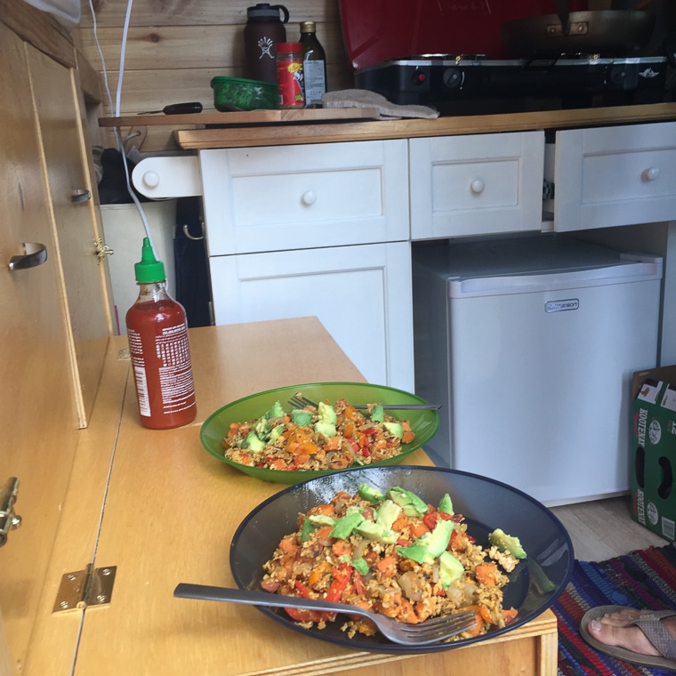 Two plates of food on the counter in a camper van