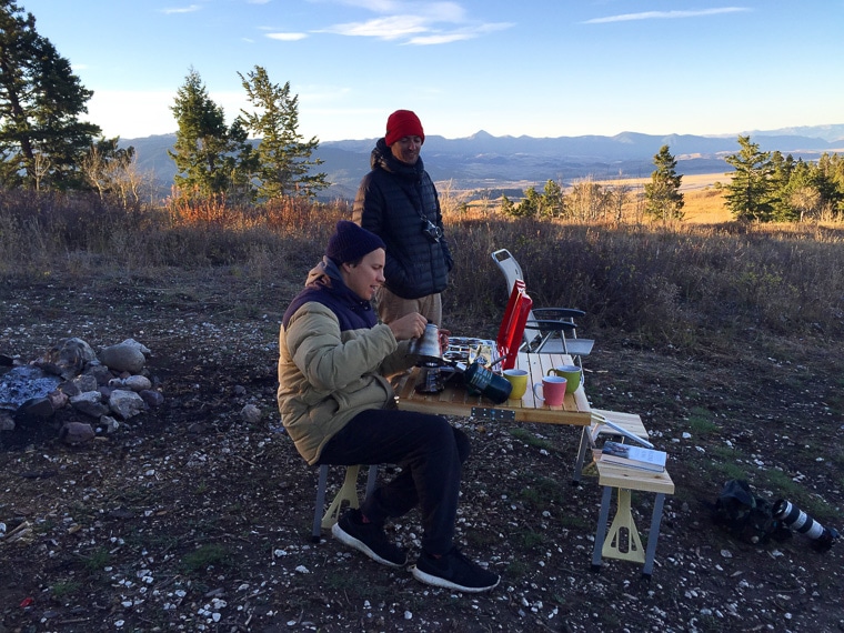 Two people at a camp table