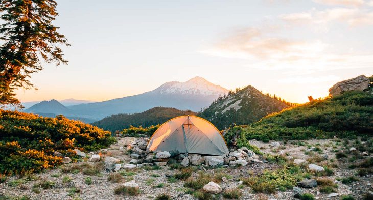 A backpacking tent with a mountain in the background