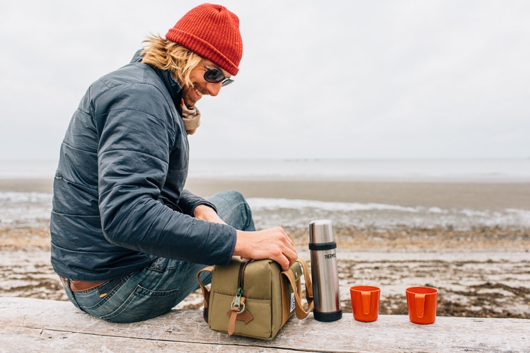 Michael at the beach with a thermos and two red cups