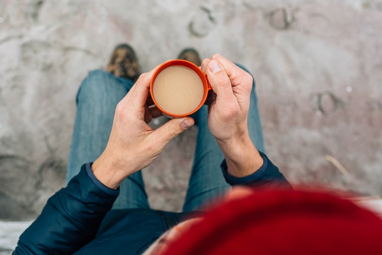 Megan holding a small red cup of London fog