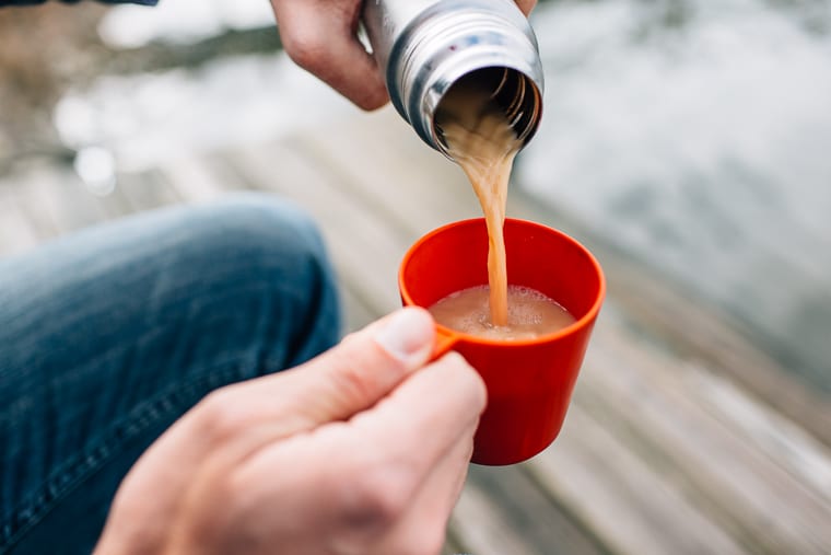 Michael pouring London fog from a thermos into a small red cup