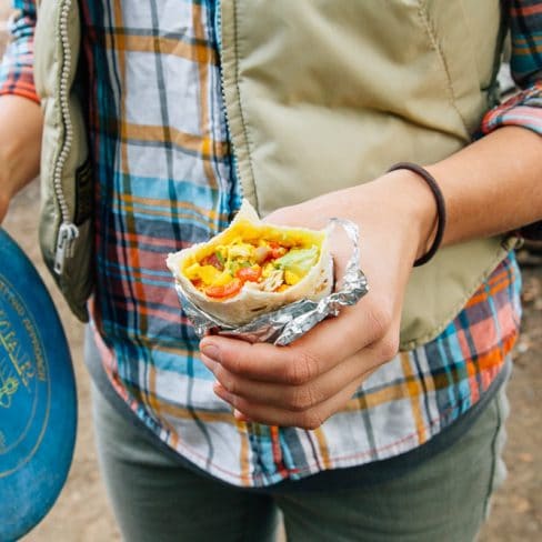 Megan holding a tofu scramble breakfast burrito