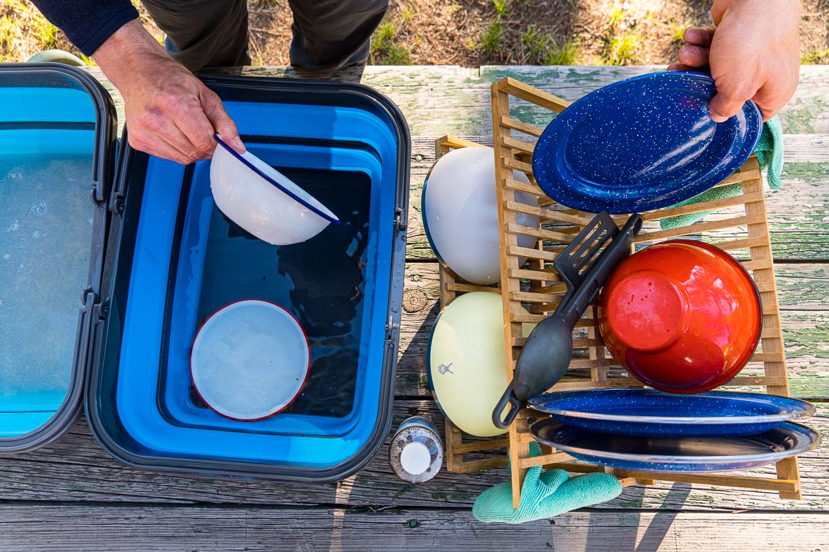 Michael rinsing a dish and placing another on a drying rack