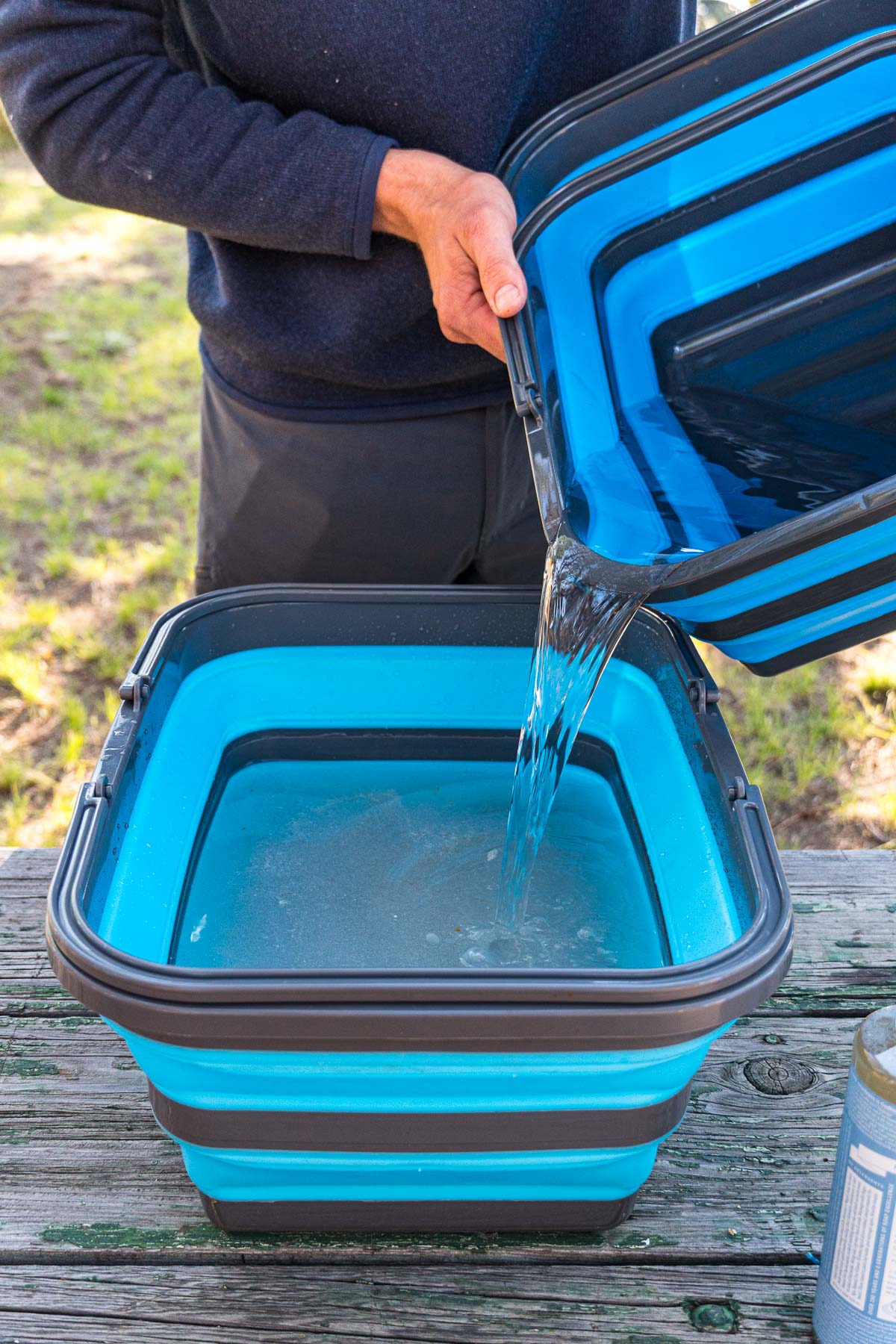 Pouring rinse water into the wash bucket