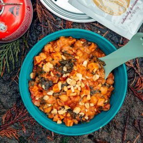 A blue bowl of sweet potato stew on a natural background