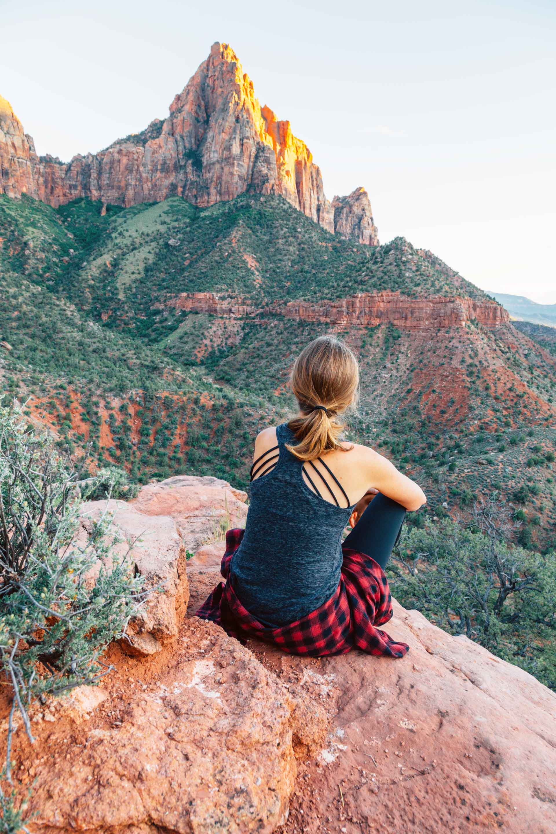 Megan sitting on a rock taking in the view from the watchmen trail