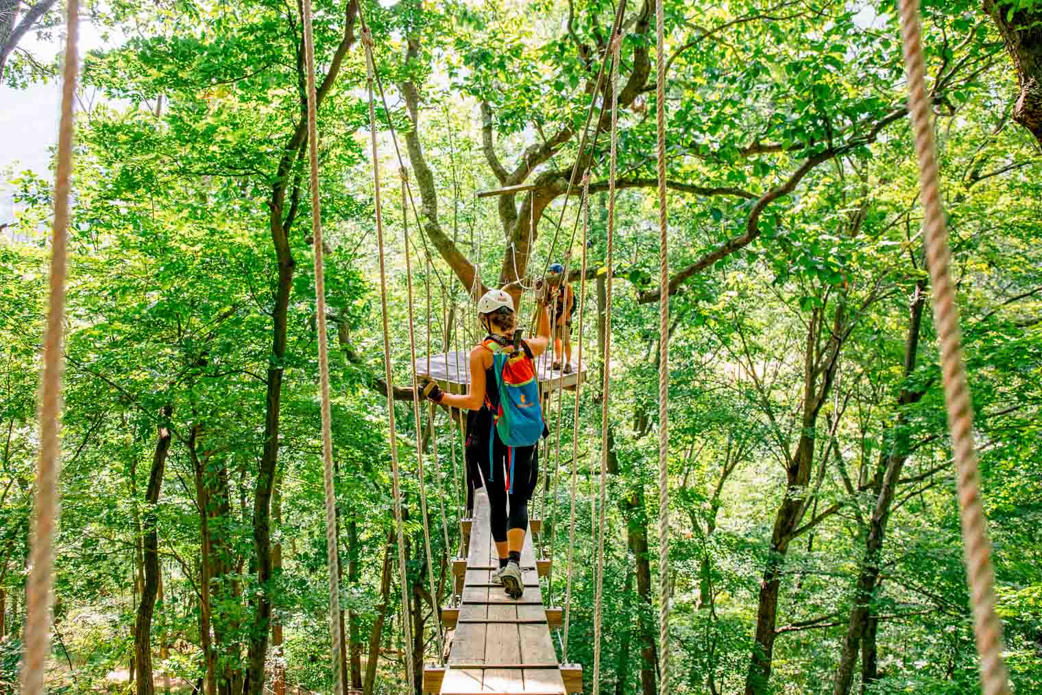 Megan crossing a rope bridge on a zipline course at NRocks in West Virginia