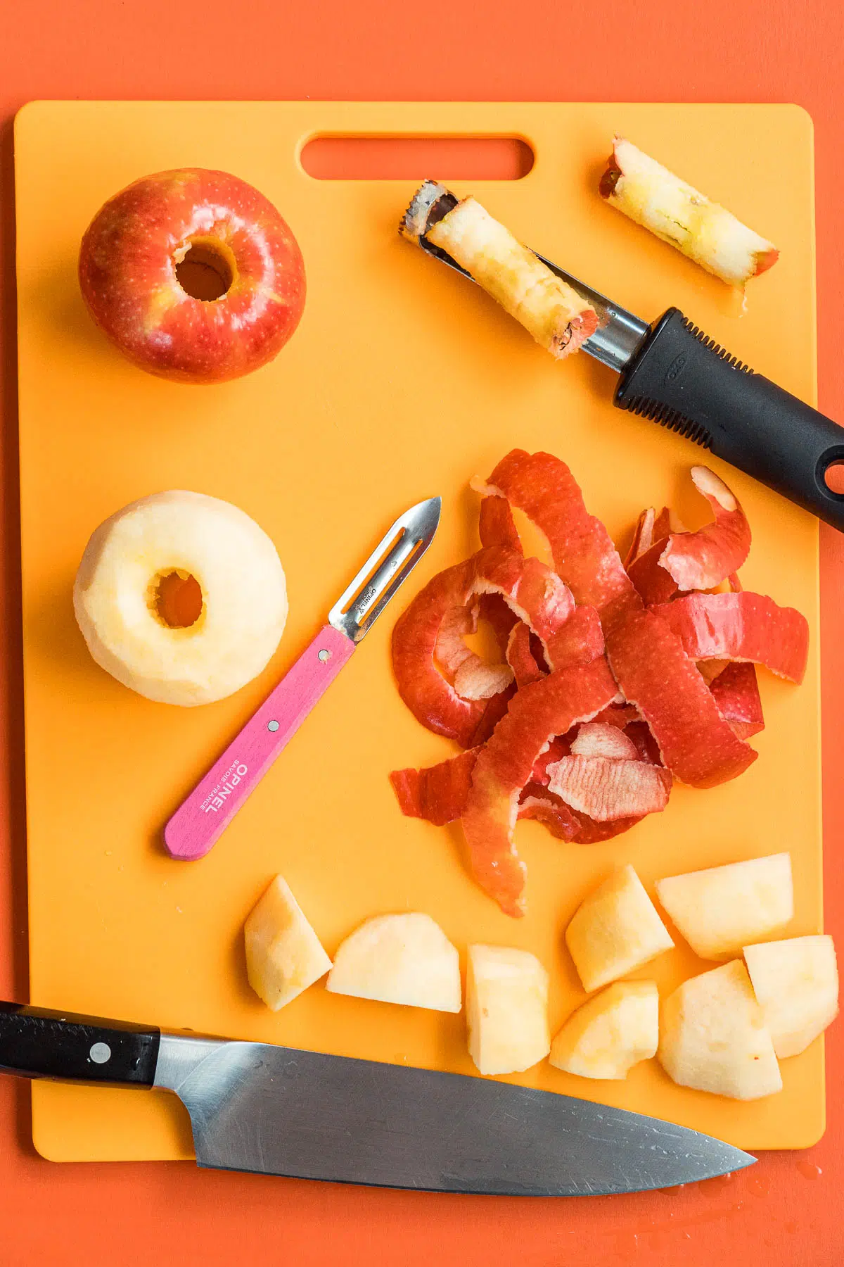 Apples that have been peeled and chopped on a cutting board.