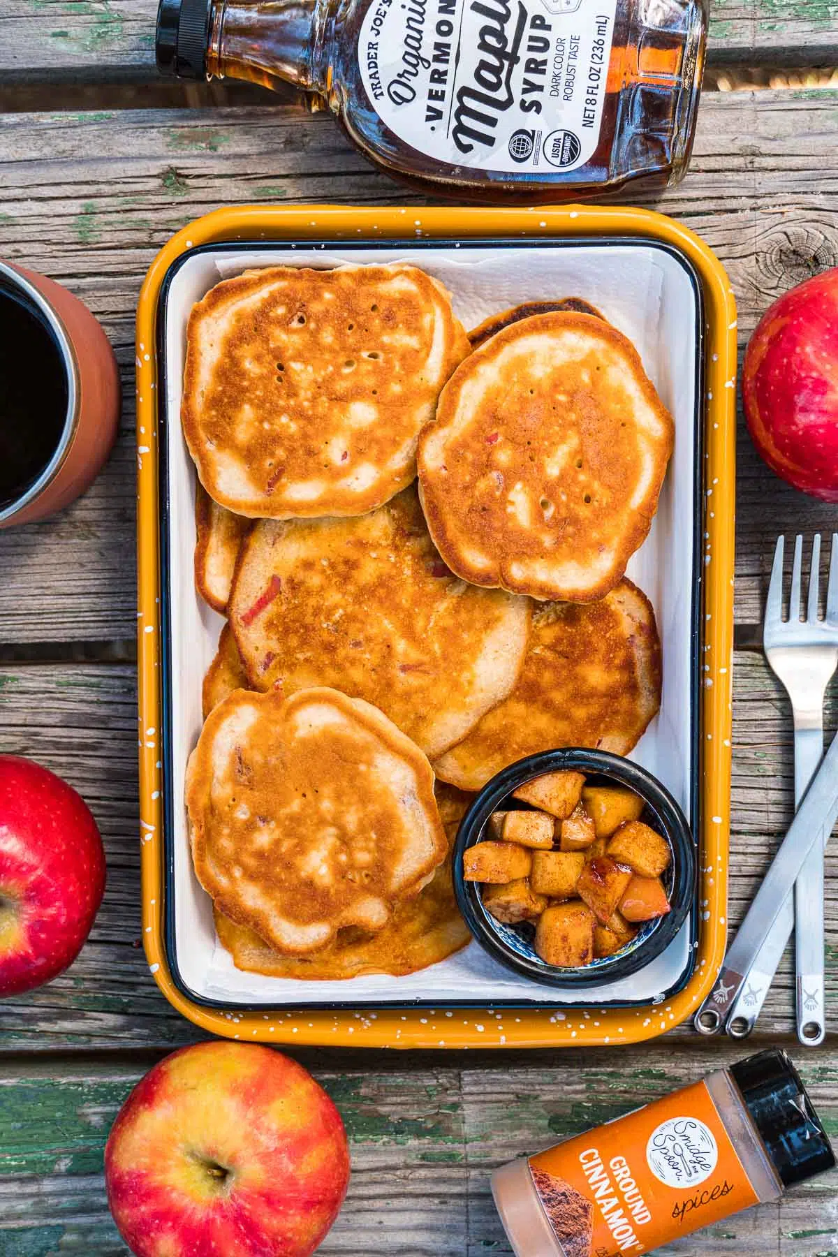 A serving dish loaded with apple pancakes.