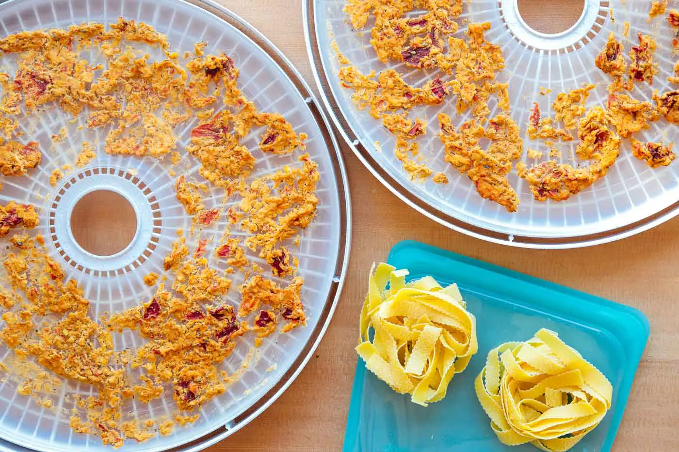 Red lentil marinara sauce on dehydrator trays