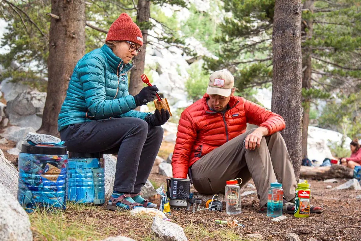 Megan and Michael eating oatmeal at a backpacking campground
