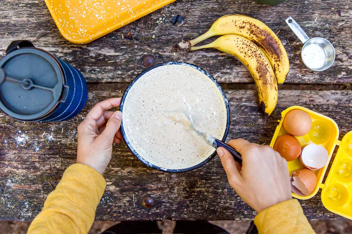 An overhead view of Megan mixing pancake batter in a bowl.