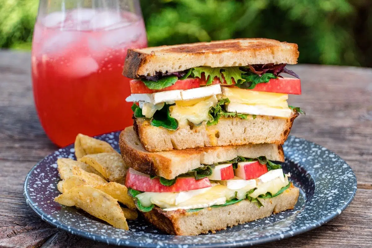 Grilled cheese sandwiches stacked on a blue plate