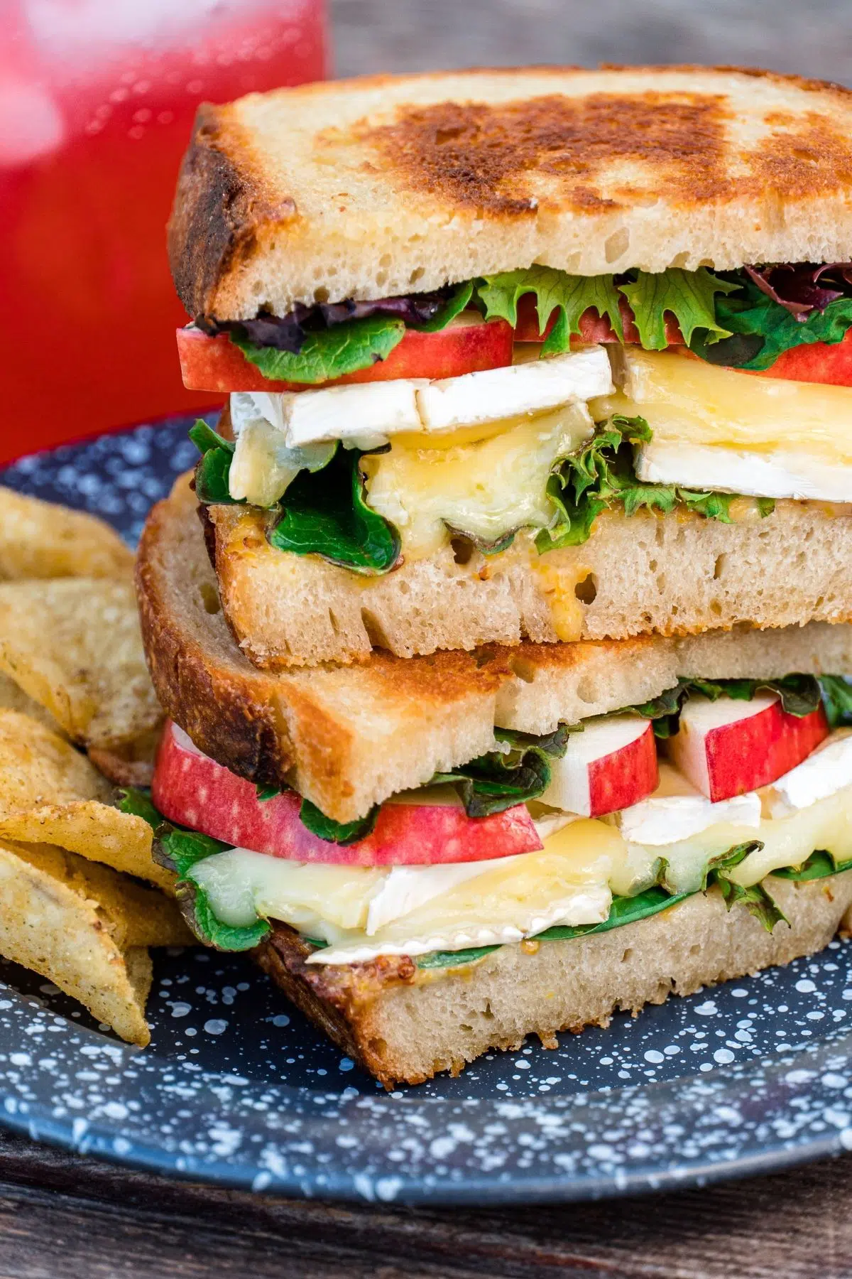 Grilled cheese sandwiches stacked on a blue plate