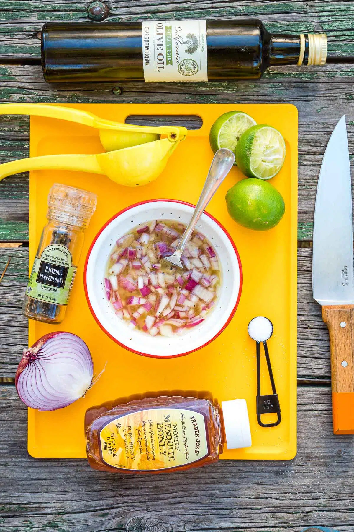 Dressing in a bowl surrounded my ingredients