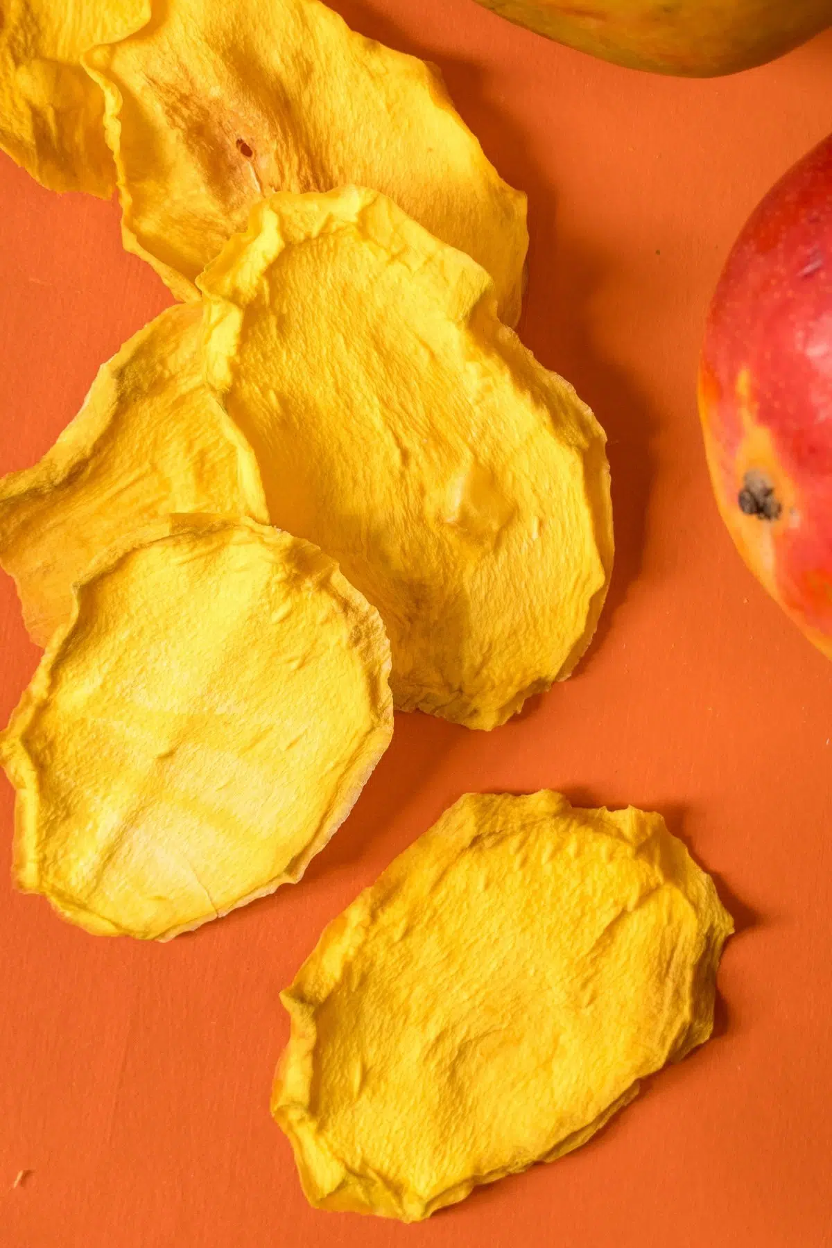 Dried mango on a red background