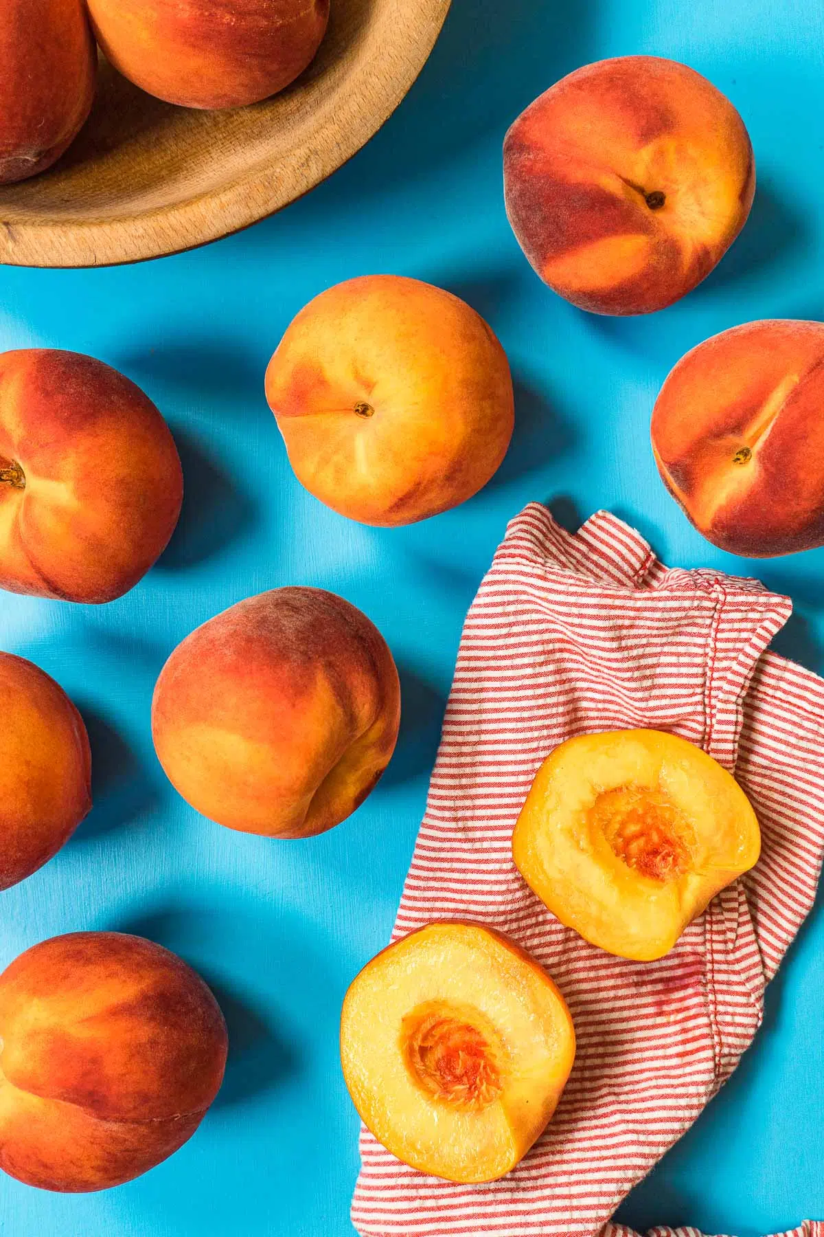 Several ripe peaches on a blue background