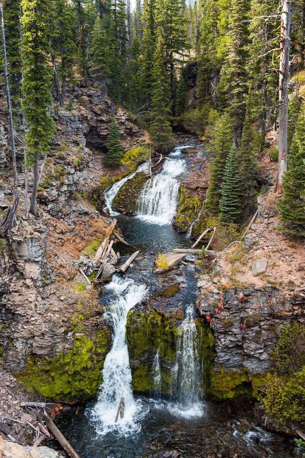 A two-tiered waterfall cascading down rocks