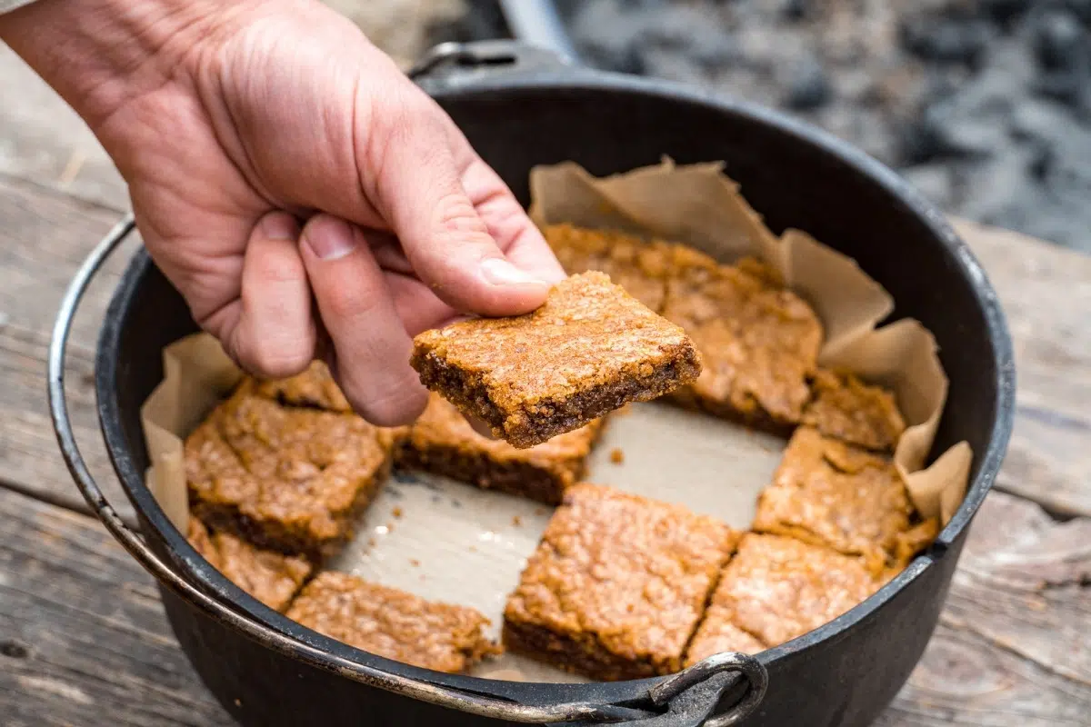 Michael picking up a Blondie out of a Dutch oven