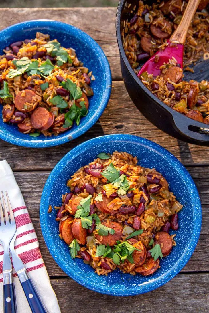 A blue bowl of red beans and rice on a natural surface