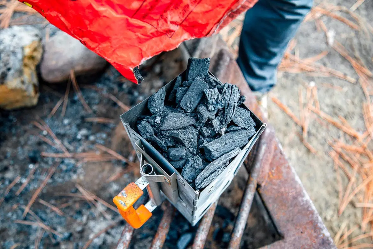 Michael filling a chimney starter with charcoal