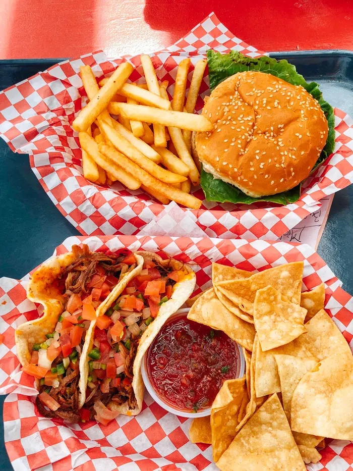 Buffalo burger and buffalo brisket tacos on a tray