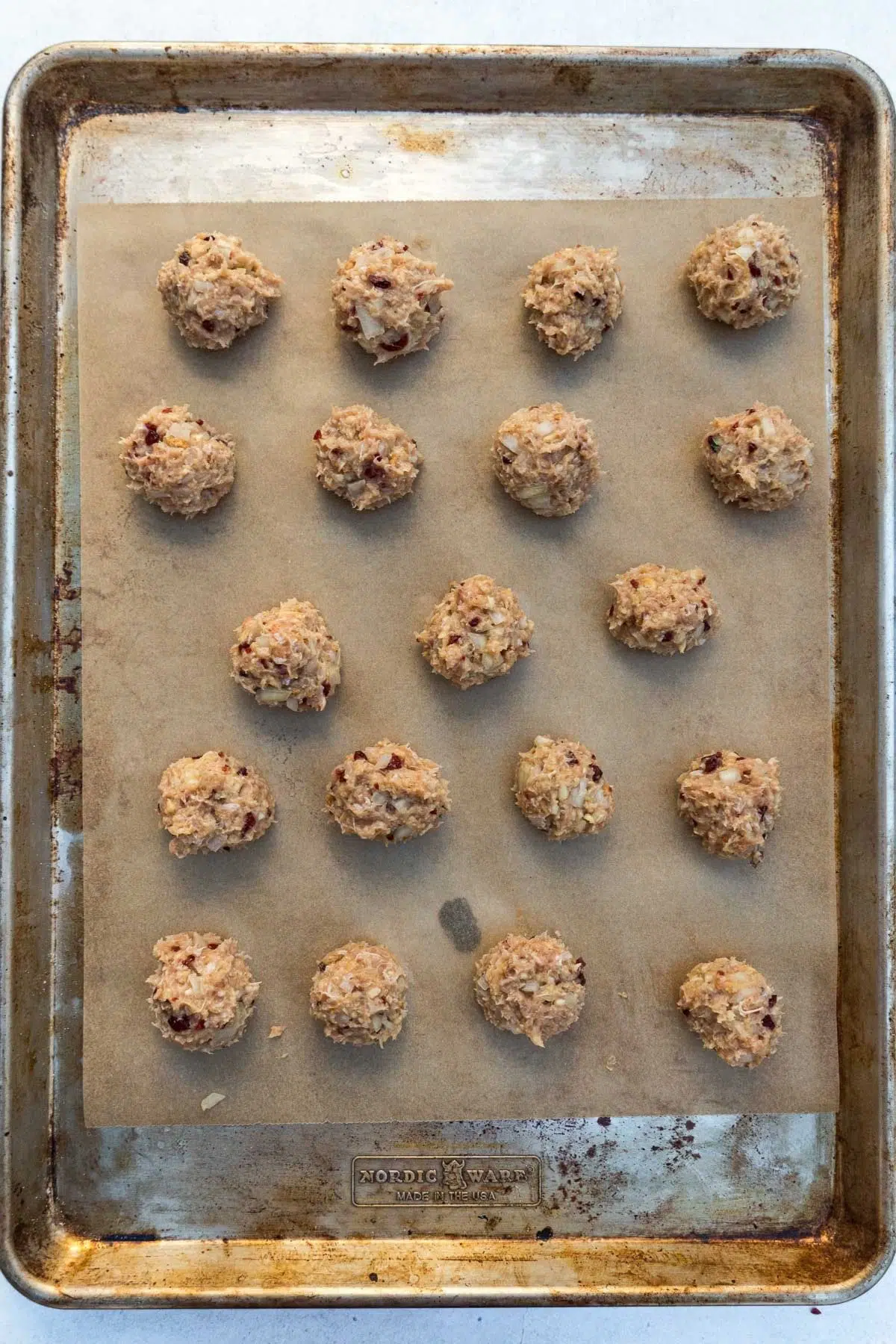 Turkey meatballs arranged on a lined baking sheet