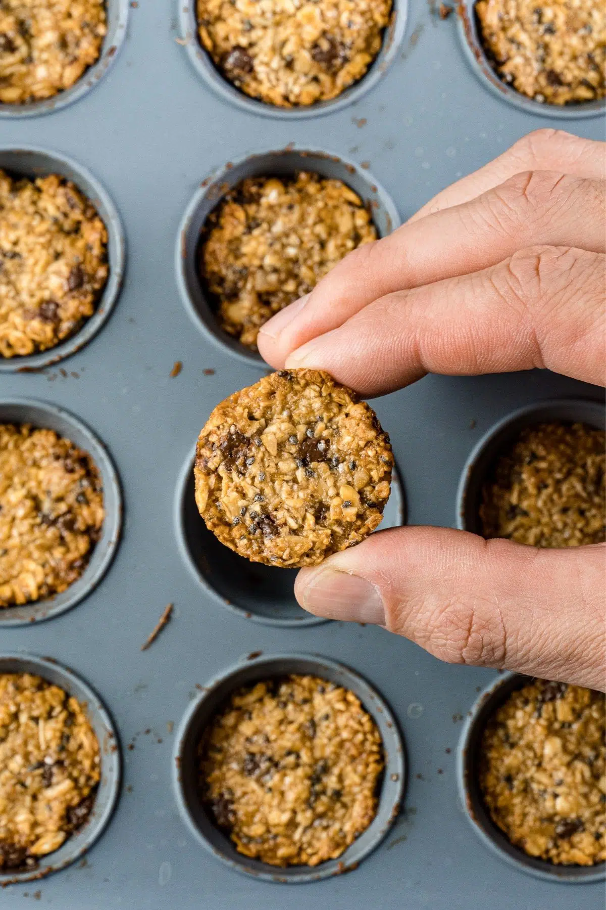 Michael lifting a granola bite out of a baking tin