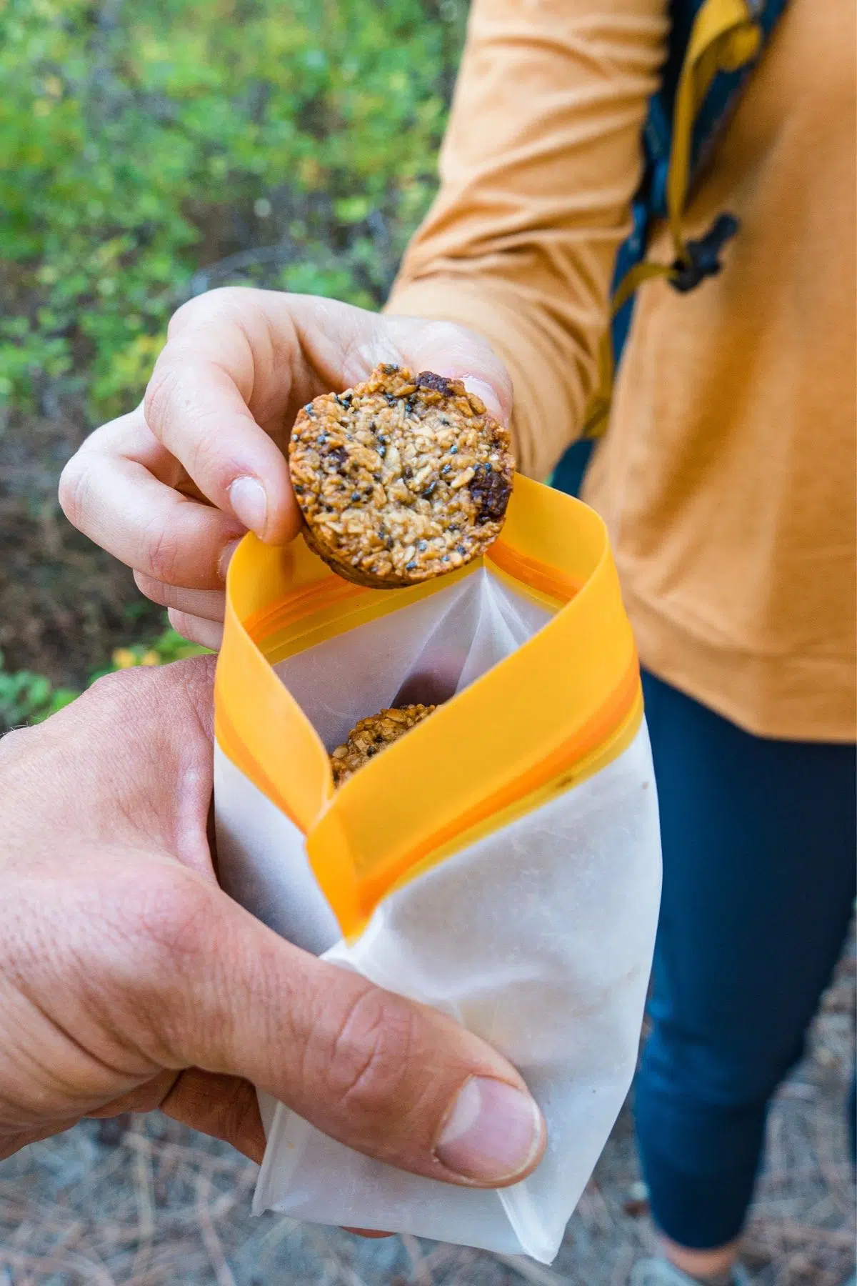 Megan taking a granola bite out of a reusable baggie