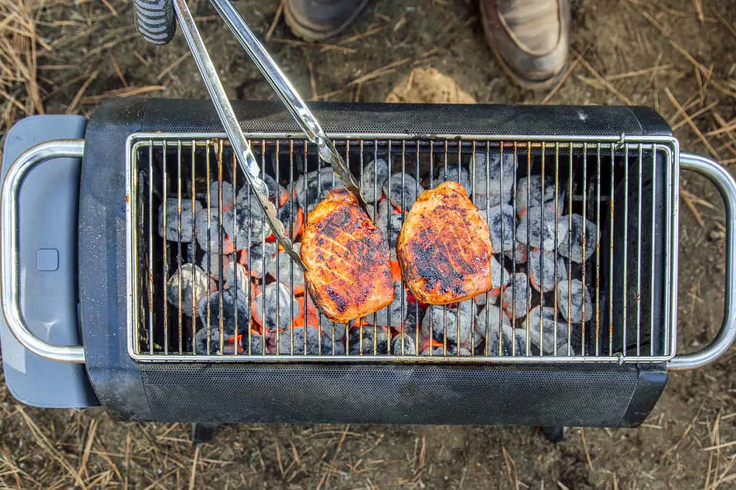 Grilling pork loin on a camping grill