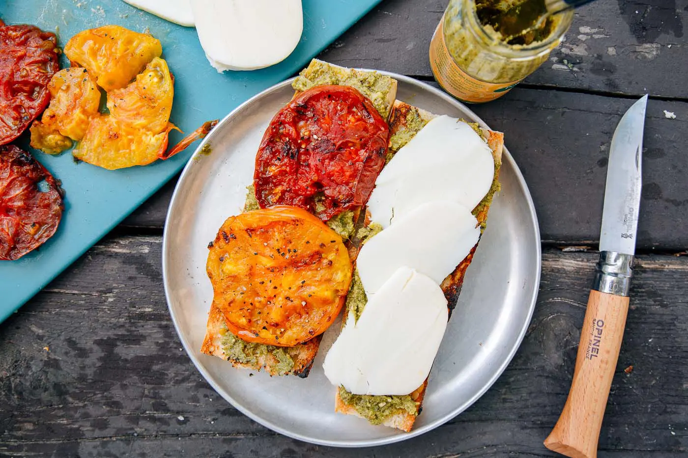 Grilled tomatoes and slices of cheese on a baguette