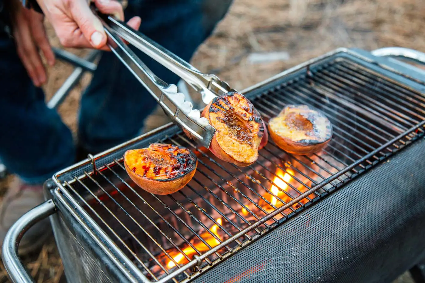 Three peaches on a grill