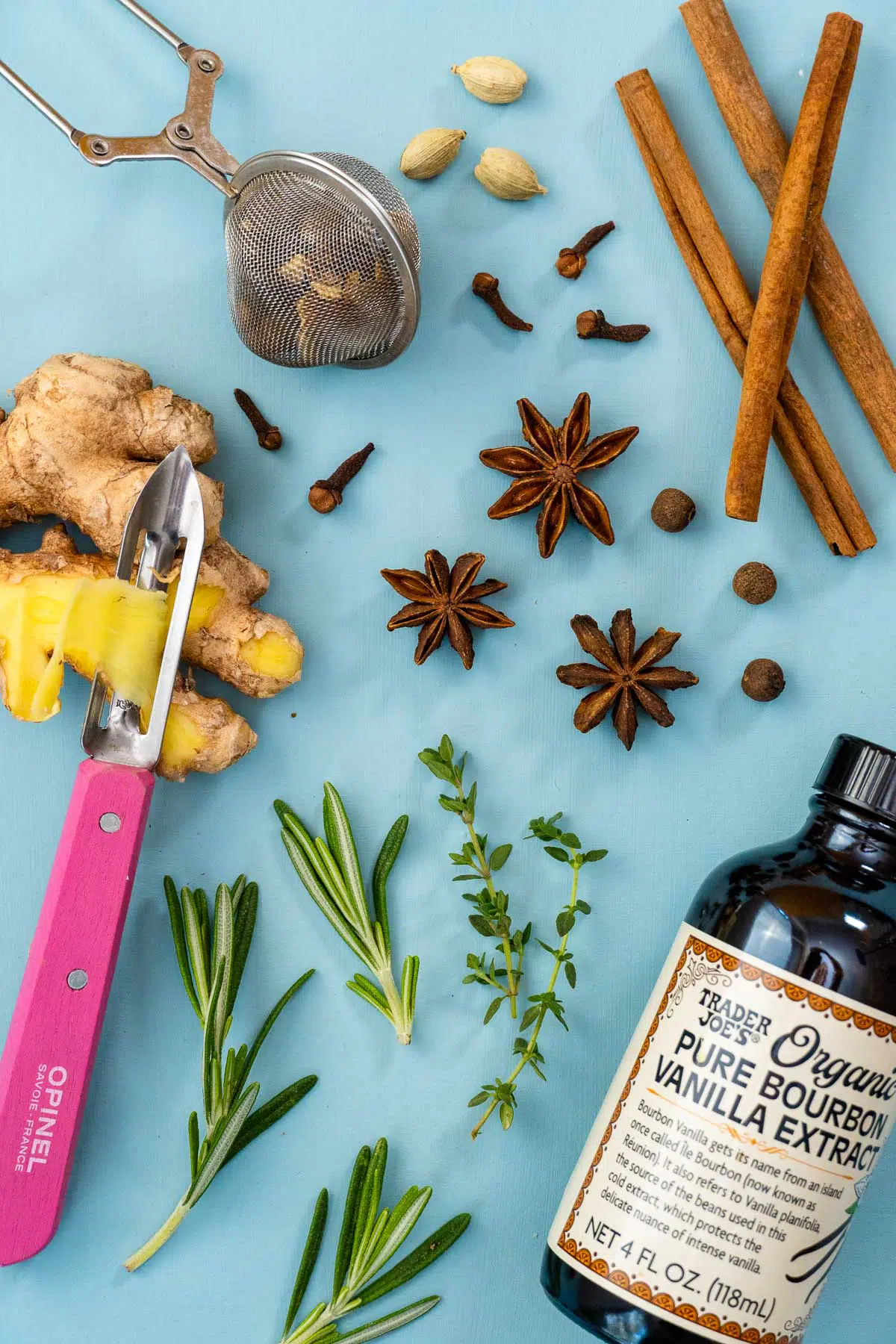 Assorted spices and aromatics on a blue background