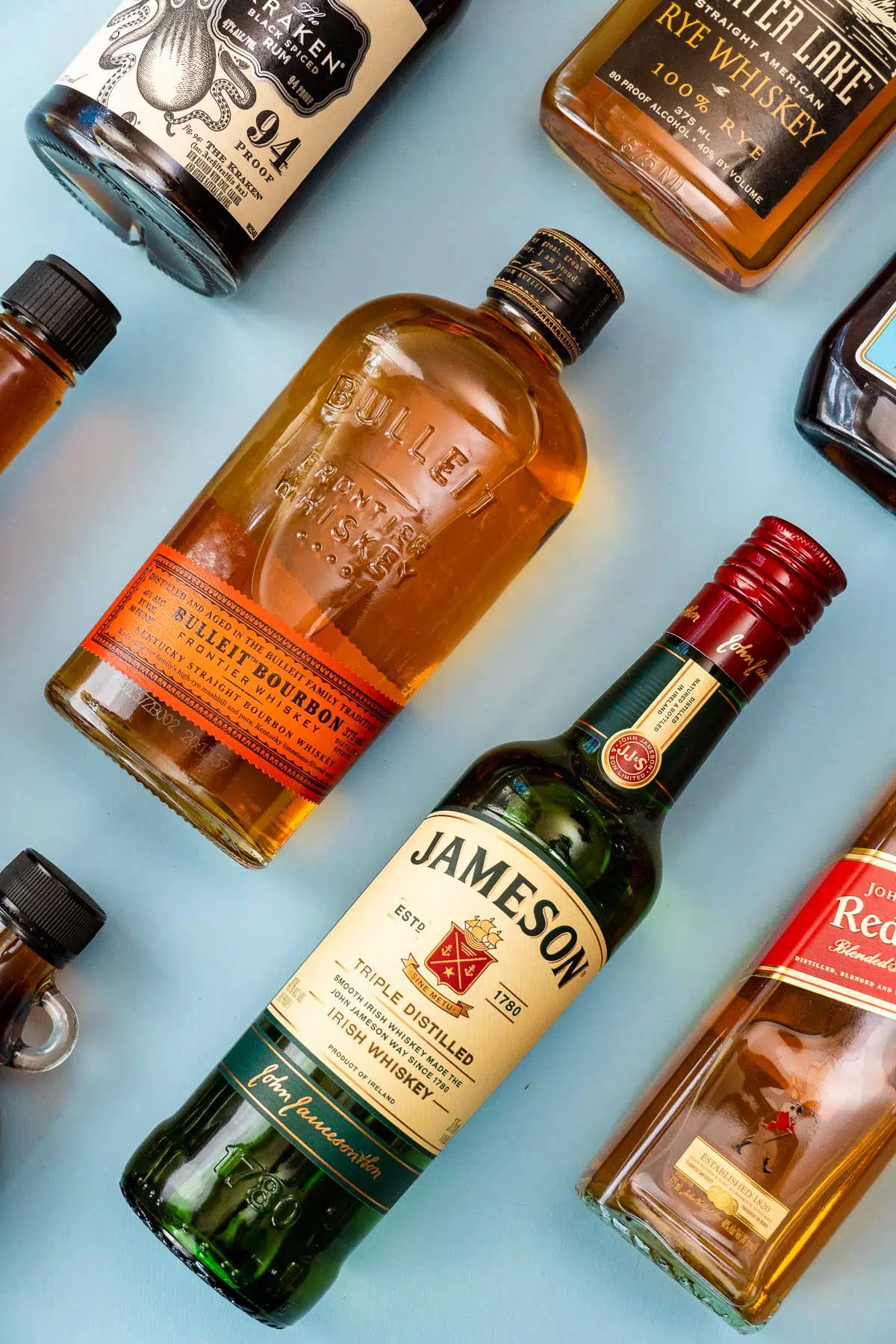 Assorted liquor bottles on a blue background