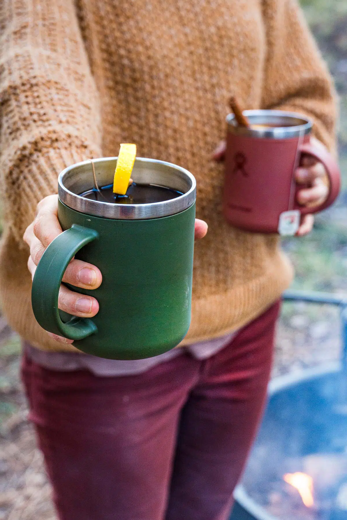 A woman holding two mugs