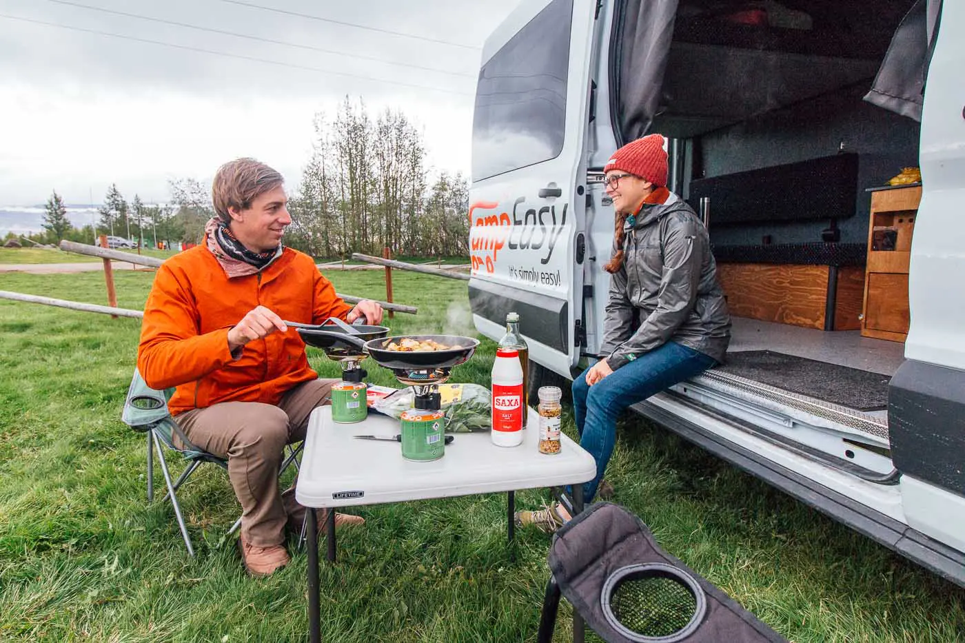 A couple cooking dinner at a campground in Iceland