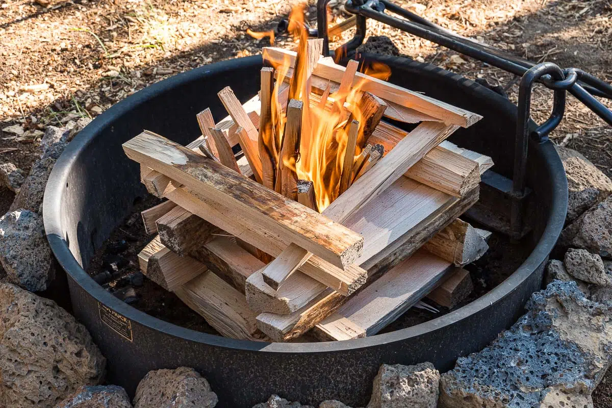 Wood logs arranged in a log cabin campfire formation