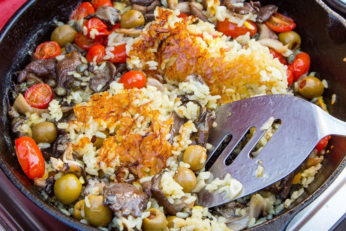 A close up of paella socarrat (crispy rice) in a skillet