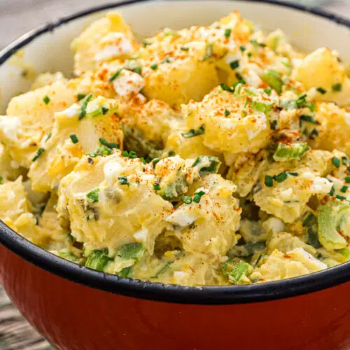 Potato salad in a red serving bowl