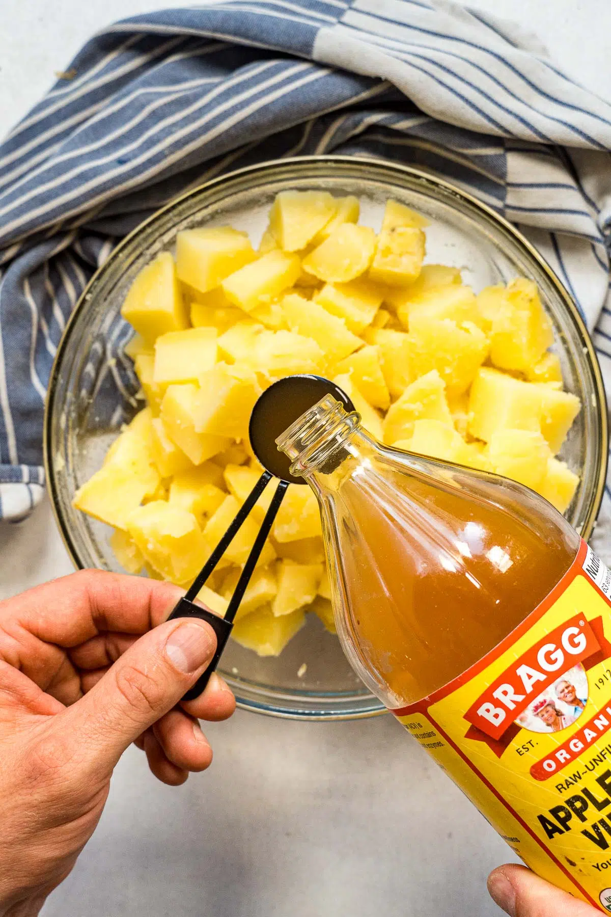 Adding vinegar to cubed potatoes