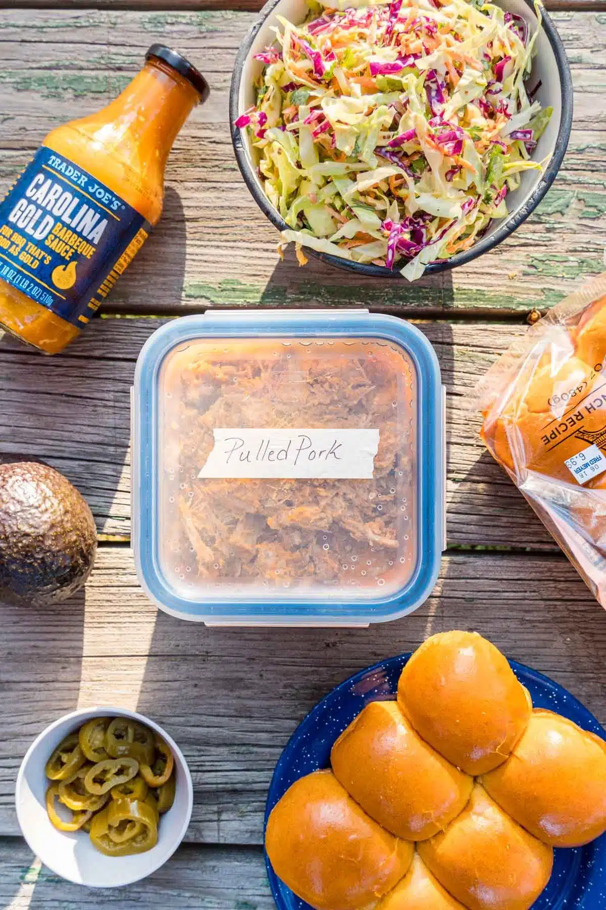 Ingredients for pulled pork on a wooden table.