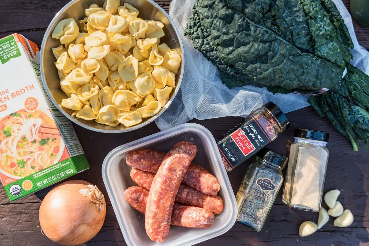 Tortellini soup ingredients laid out on a table